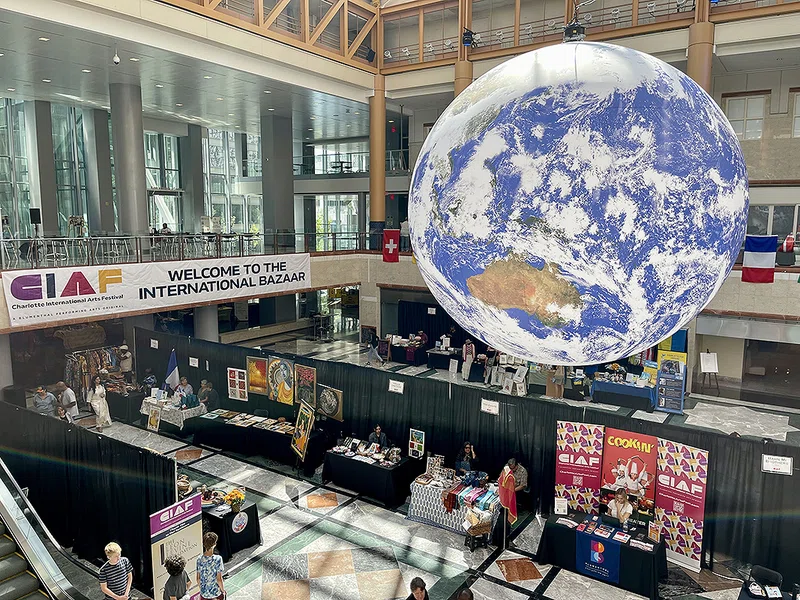 U.K. artist Luke Jerram's Earth exhibit Gaia hangs above the International Bazaar in Founders Hall.